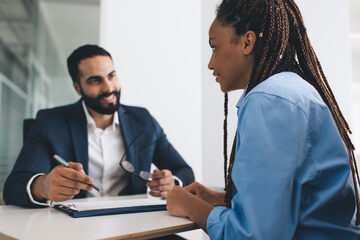 Two professionals meeting at a desk
