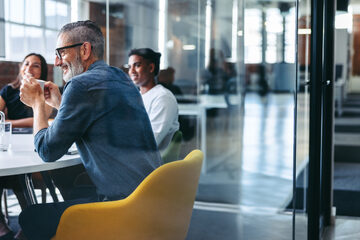 professional people sitting around a meeting table.